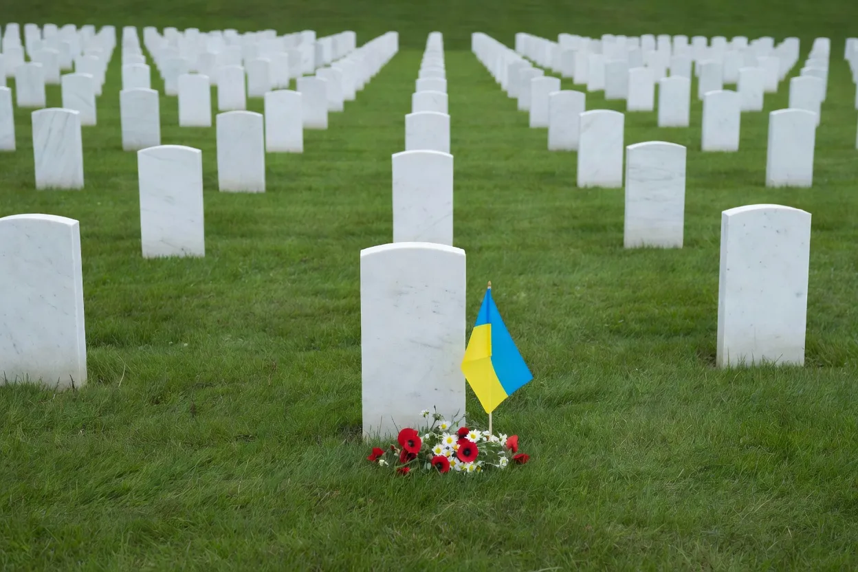 Rows of headstones in a Commonwealth War Graves Commission military cemetery with a Ukrainian-Canadian wreath